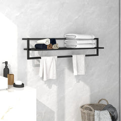 Black iron towel rack with shelf holding folded white towels, mounted on a bathroom wall.
