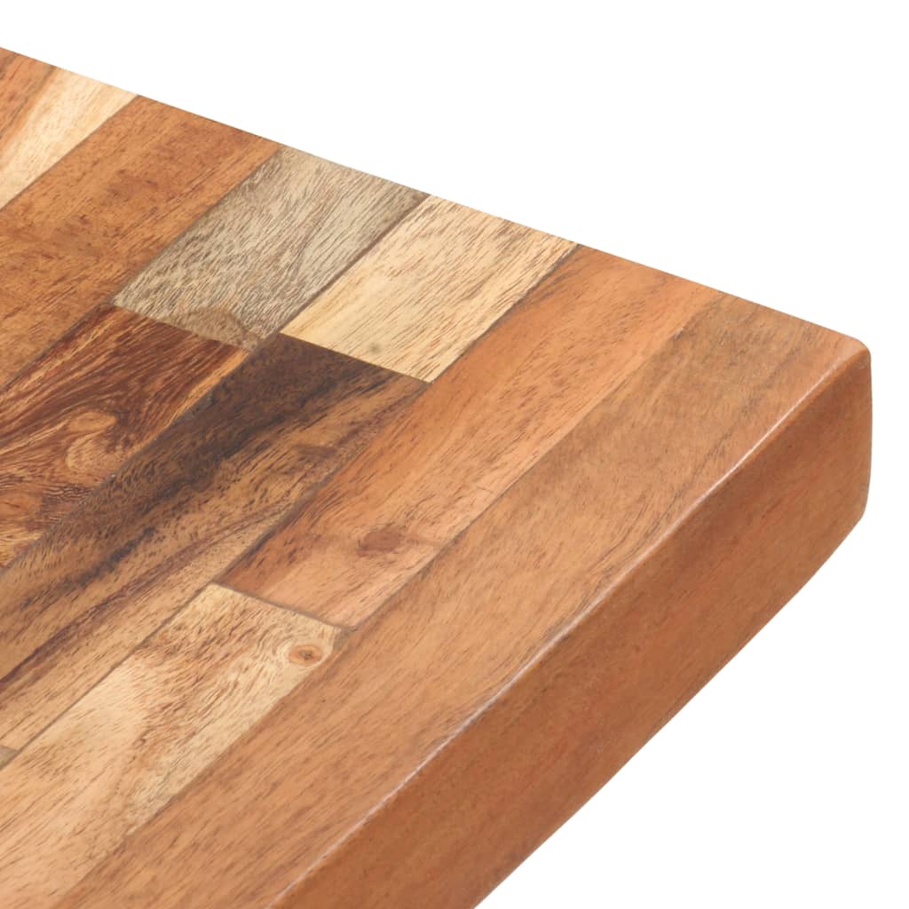 A close-up of a solid acacia wood chopping board with a patchwork design.