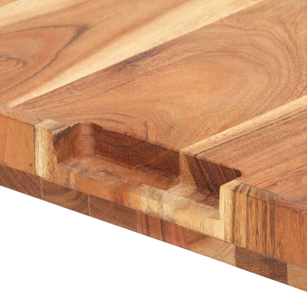 A close-up of a solid acacia wood chopping board with finger grooves.