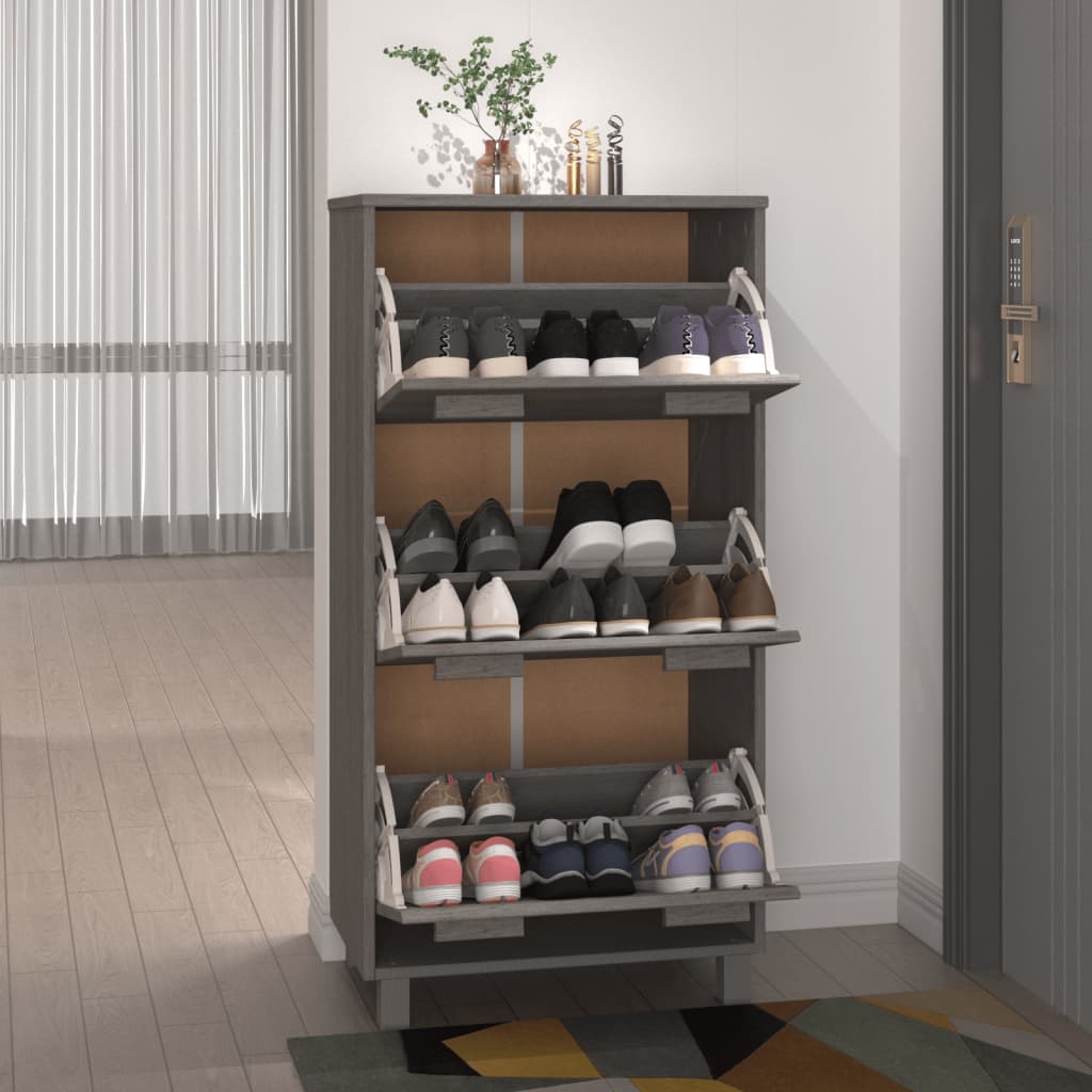 Light gray solid pine wood shoe cabinet with three flip drawers storing various shoes.