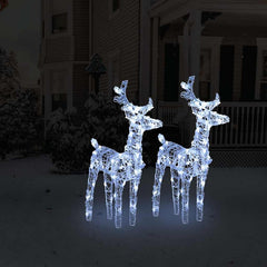Two lit acrylic reindeer figures with 80 cold white LEDs on a snowy lawn.