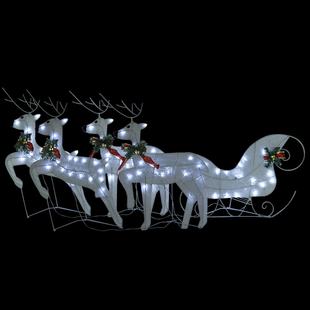White LED-lit reindeer and sleigh Christmas decoration with greenery and red bows outdoors