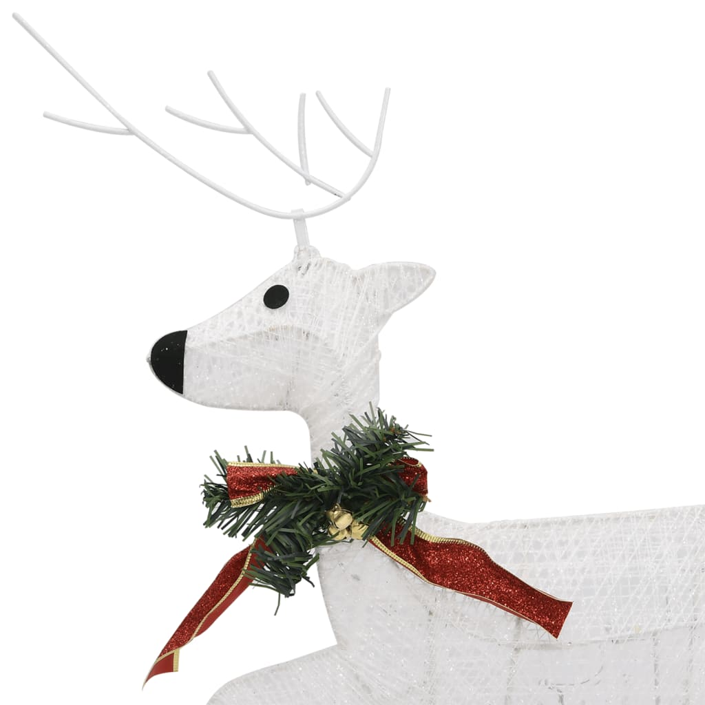 White outdoor reindeer Christmas decoration with red bow, green wreath, and antlers.
