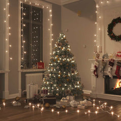 Warm white LED string lights draped around a cozy Christmas tree and room decor.
