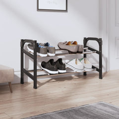 Black and silver extendable aluminum shoe rack with two shelves holding various shoes in an entryway.