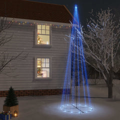 A tall blue LED Christmas cone tree with 1134 lights stands lit up in a snowy yard at night.