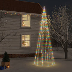 A 16 ft tall outdoor Christmas tree with colorful LED lights stands in snowy yard near a house.