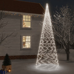 A 26-foot tall white LED Christmas tree with 3000 cold white lights, spiked base, in a snowy yard at night.