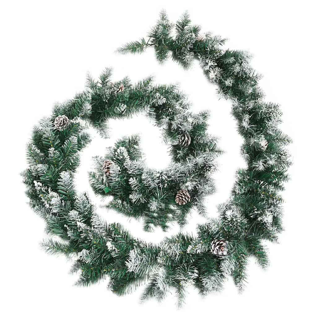 A long, green Christmas garland with flocked tips and pine cones is coiled on a white background.