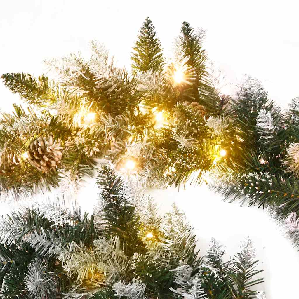 9 ft green PVC Christmas garland with warm white LED lights, flocked tips, and pine cones.