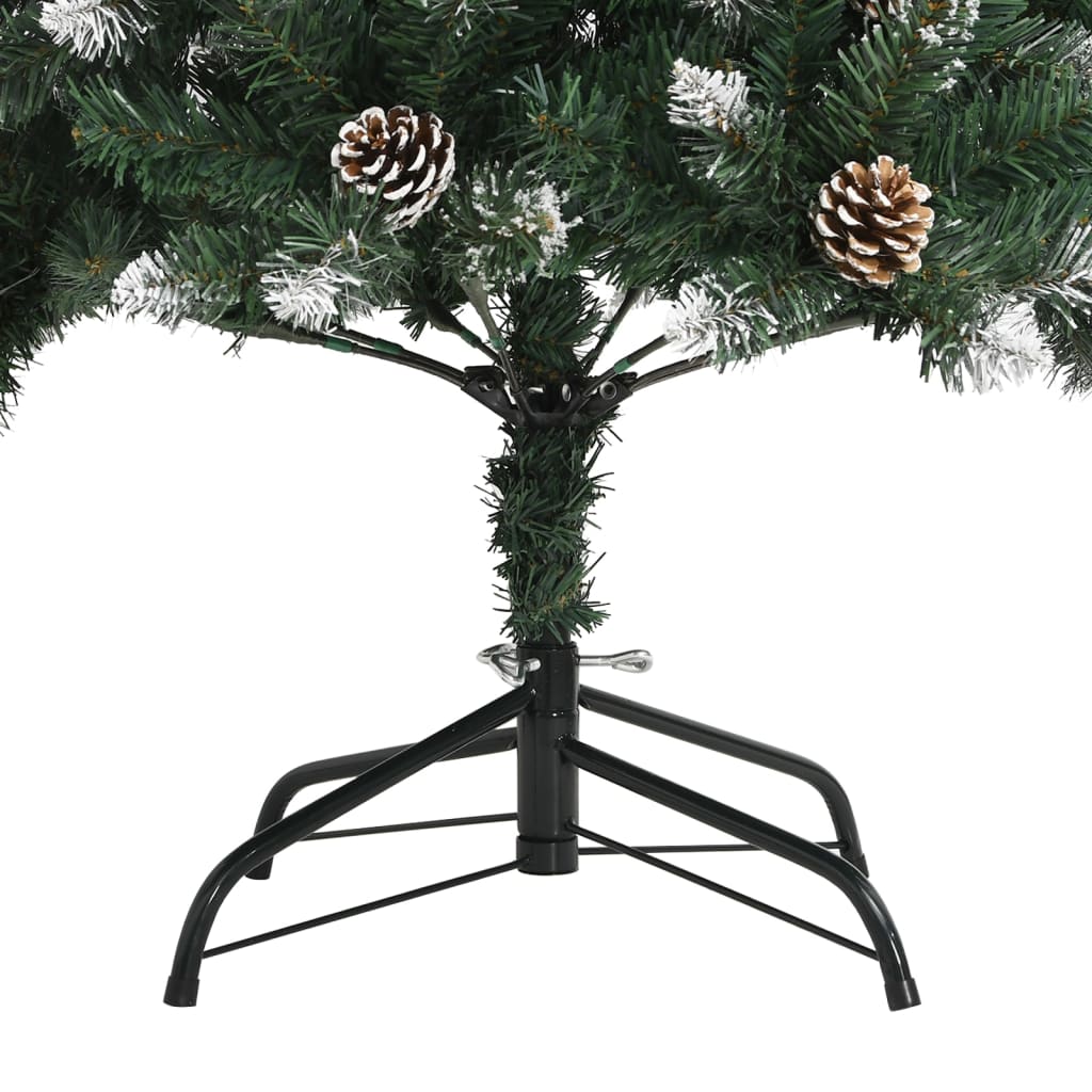 A green artificial Christmas tree with pinecones, snow, and a black metal stand.