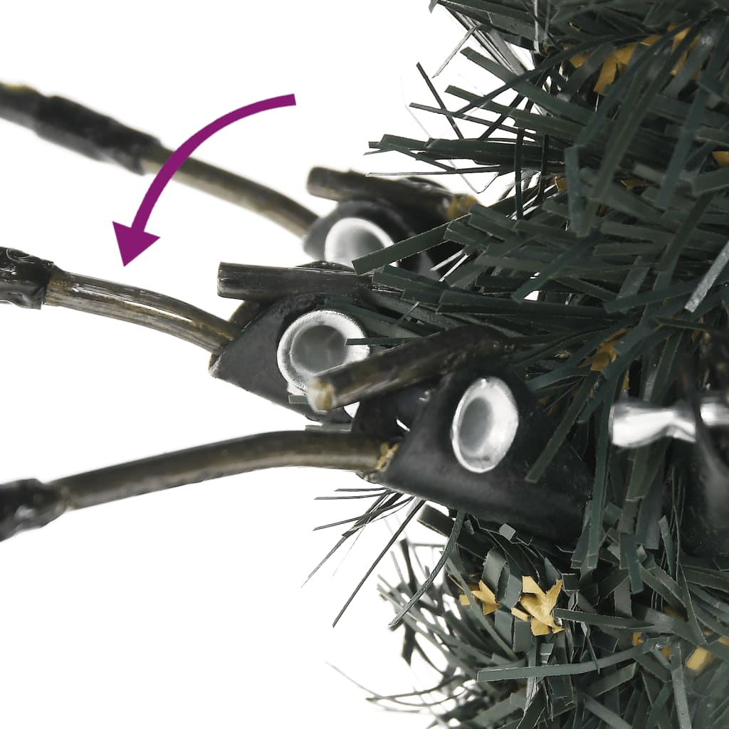Close-up of artificial Christmas tree base showing hinged branches and stand assembly.