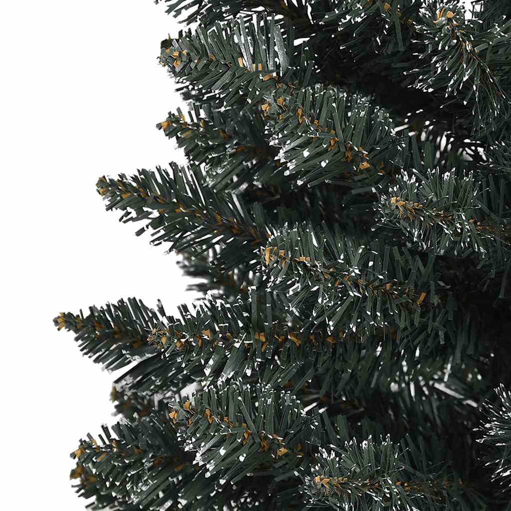 Close-up of a green artificial Christmas tree with flocked tips.