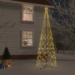 A tall 5x16 ft warm white LED cone Christmas tree glowing against a snowy house exterior at night.