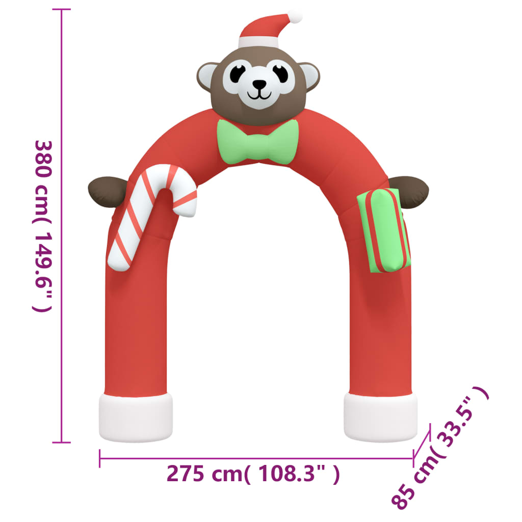 A red inflatable Christmas arch gate with a monkey wearing a Santa hat, a candy cane, and a gift box.