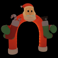 Inflatable Christmas arch gate with Santa face, multicolor LED lights, and attached stockings.