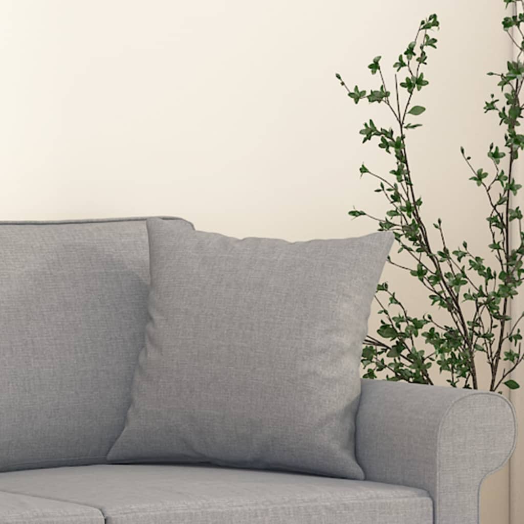 Set of two light gray fabric throw pillows, 15.7x15.7 inches, on a sofa.