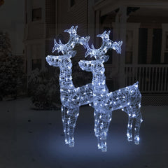 Two 39.4-inch tall acrylic LED reindeer Christmas decorations glowing with white lights on a snowy porch.