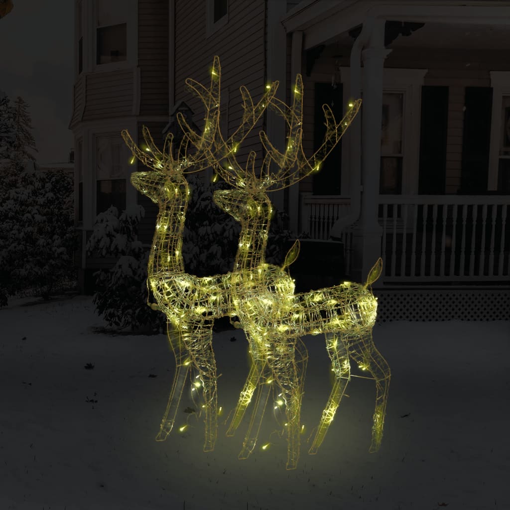 Two 47.2-inch lighted acrylic reindeer decorations with warm white LEDs on a snowy porch.