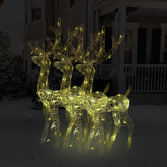 Three lighted acrylic reindeer decorations with warm white LEDs on a snowy porch.