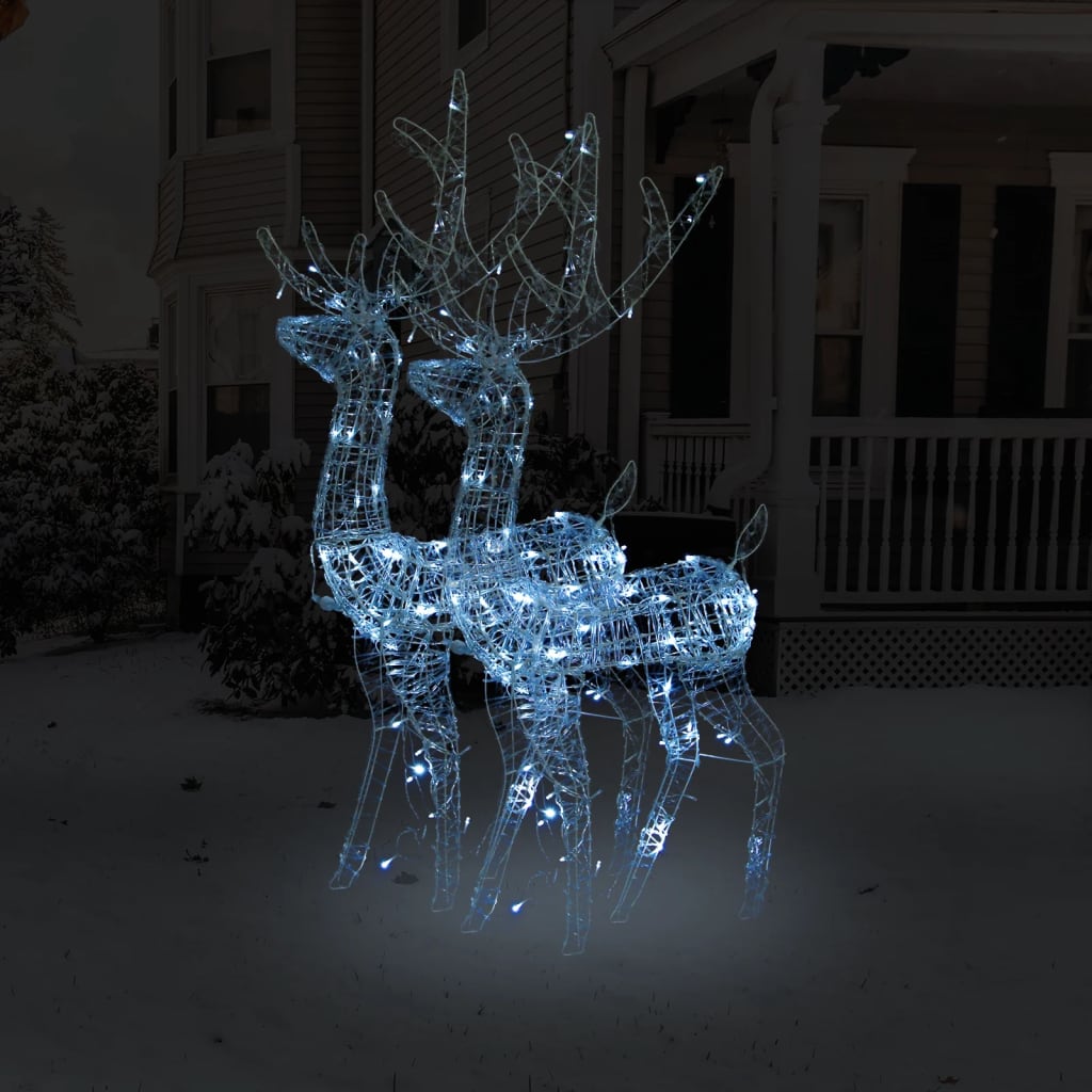 Two lighted acrylic reindeer silhouettes with cold white LEDs, standing in snowy yard.