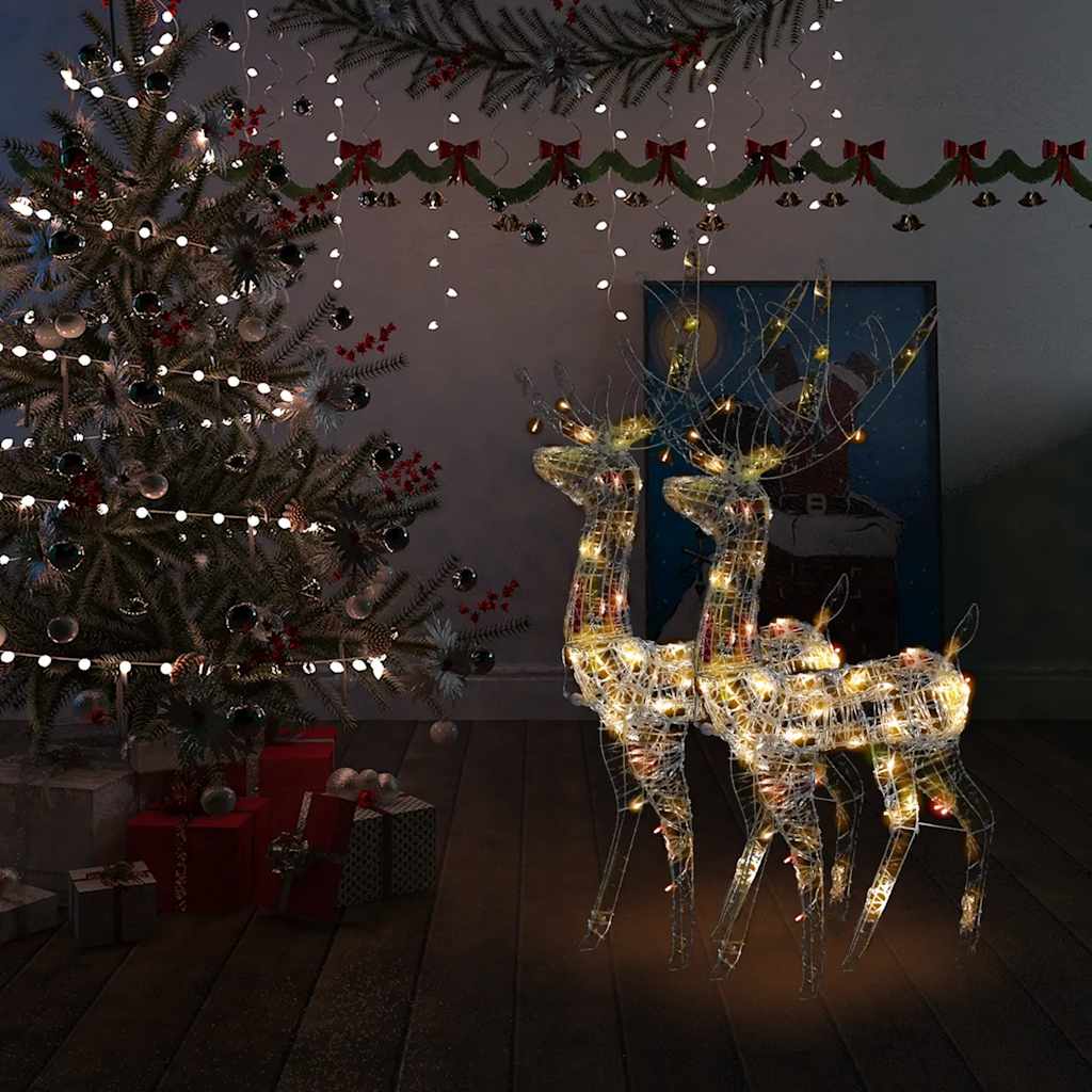 Two 47.2-inch multicolor lighted acrylic reindeer figures standing in a festive Christmas room.
