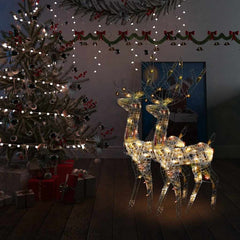 Two 47.2-inch multicolor lighted acrylic reindeer figures standing in a festive Christmas room.