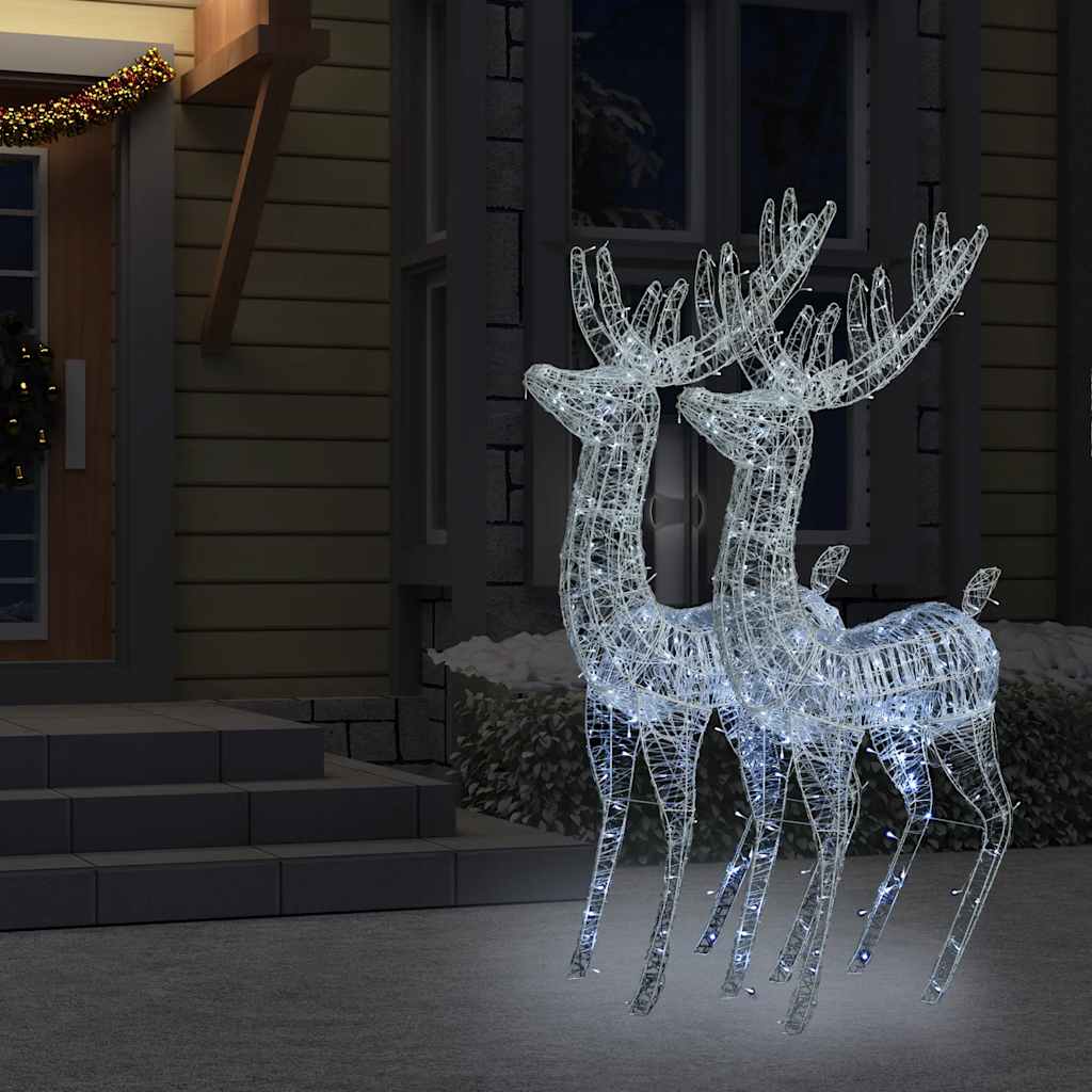 Two tall acrylic reindeer figures lit by 250 cold white LEDs, standing together outdoors at night.