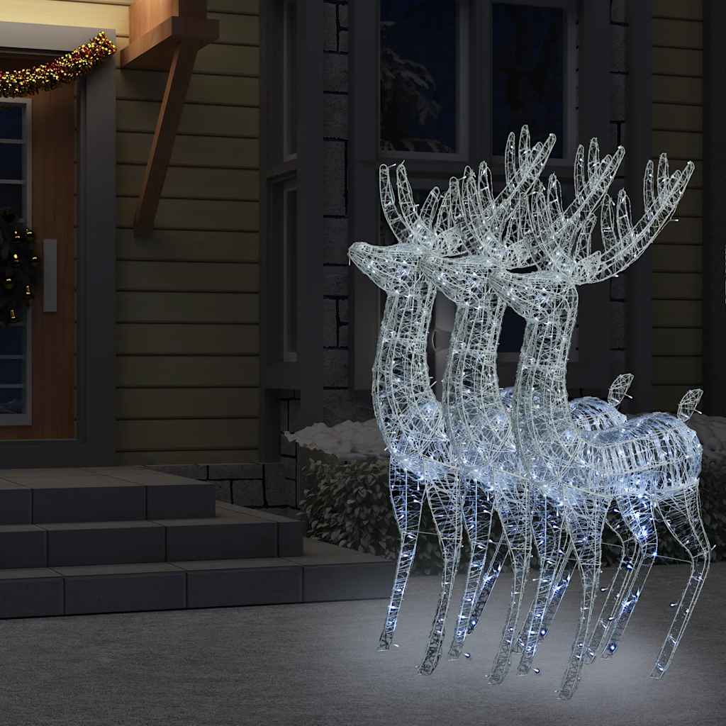 Three 70.9-inch white acrylic reindeer silhouettes with 250 cold white LEDs on a snowy yard at night.
