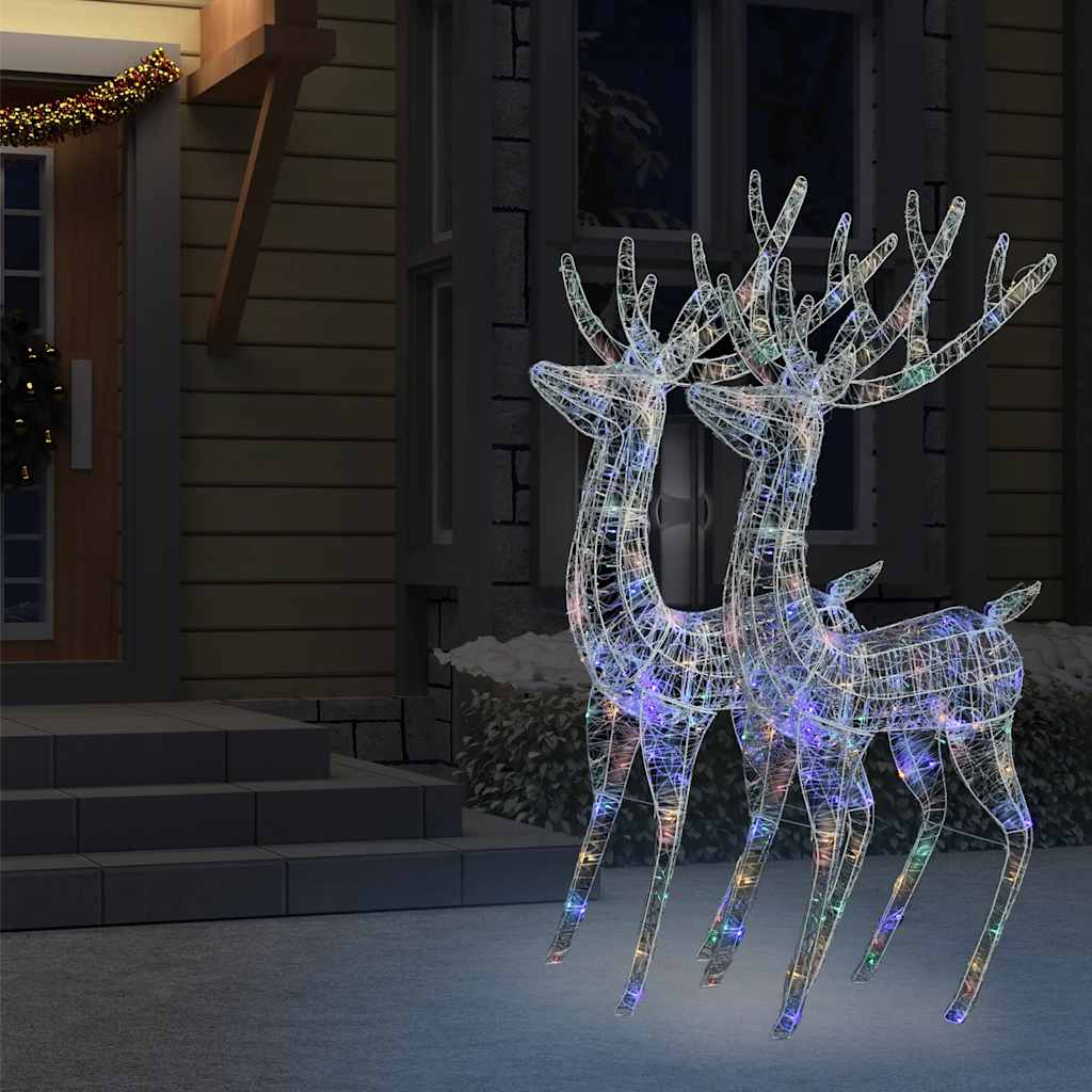 Two 70.9-inch illuminated acrylic reindeer with multicolor LEDs on a snowy porch at night.