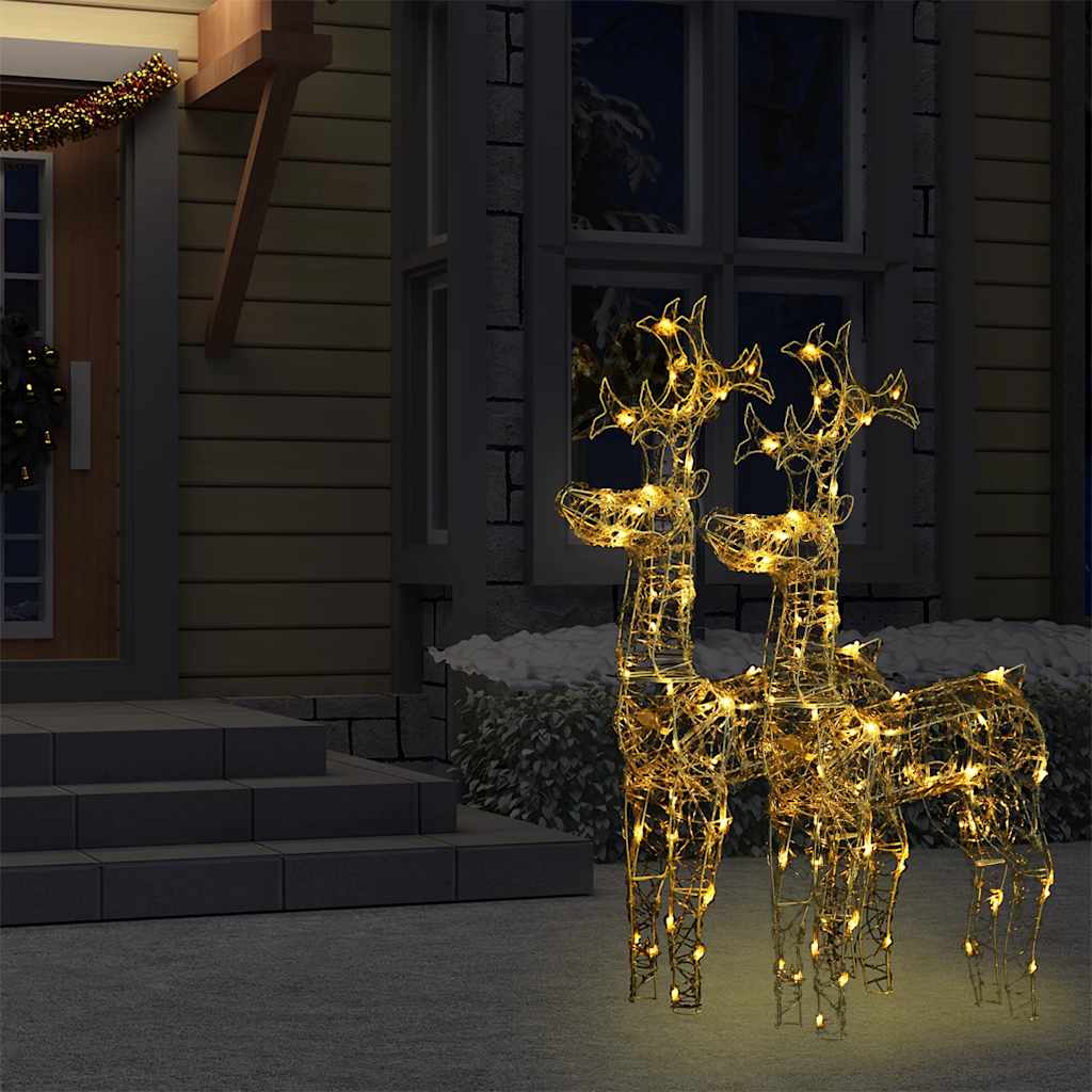 Two 39.4-inch lighted acrylic reindeer decorations glowing with warm white LEDs on a porch at night.