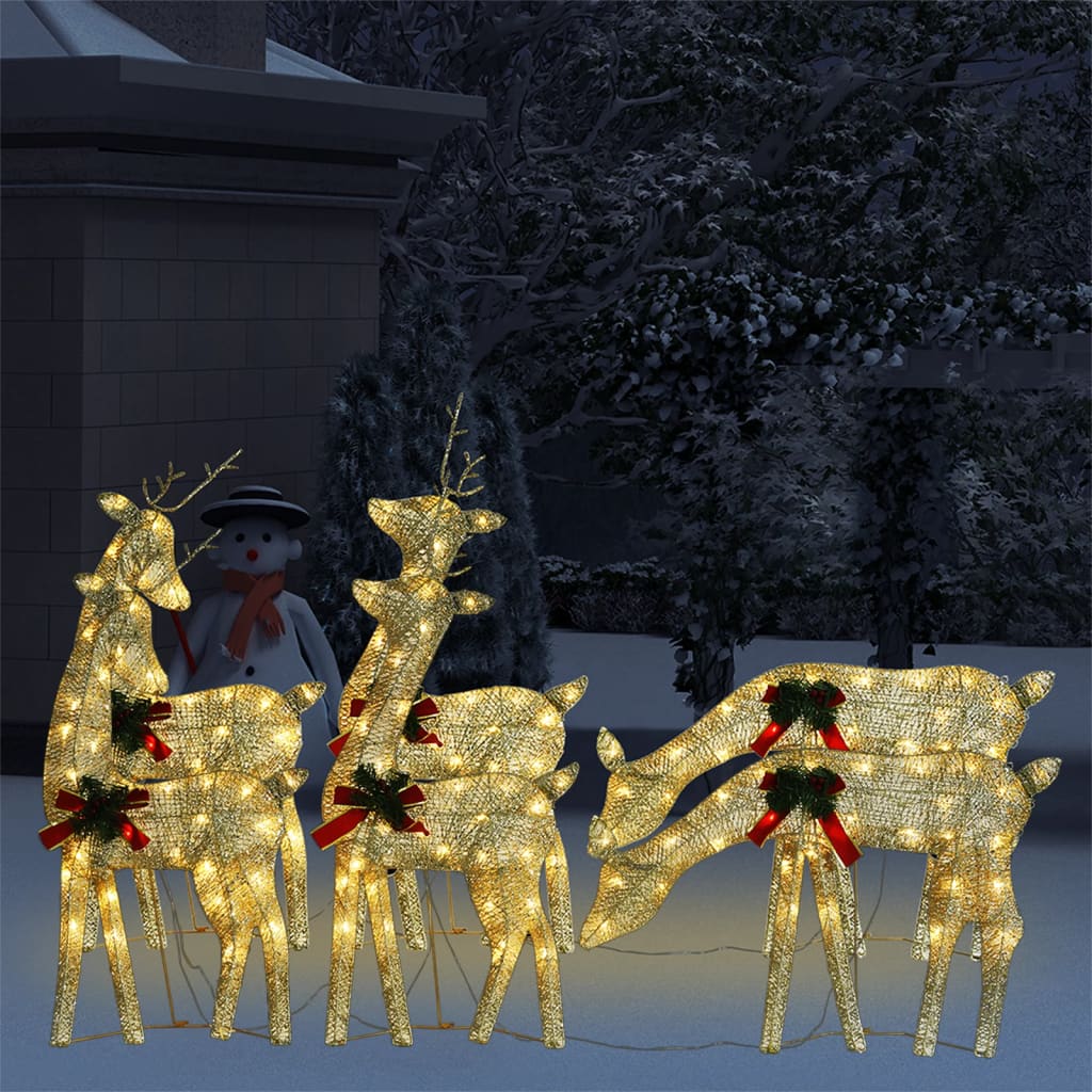 Six gold mesh reindeer figures with warm white LED lights, arranged in a snowy outdoor scene.