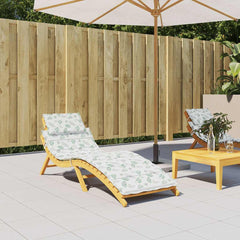 Leaf-pattern Oxford fabric sun lounger cushion on wooden chair in garden patio.