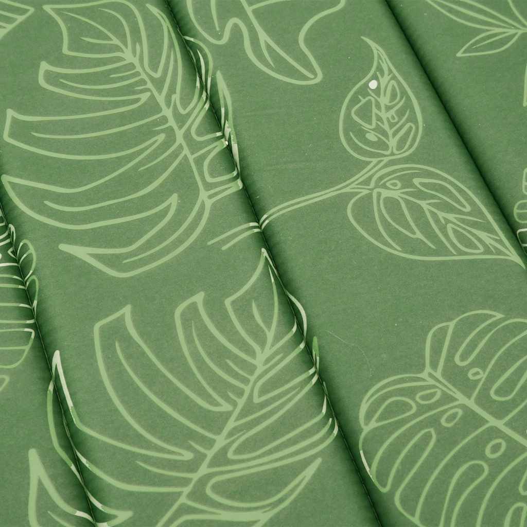 A green sun lounger cushion with a light green leaf pattern.