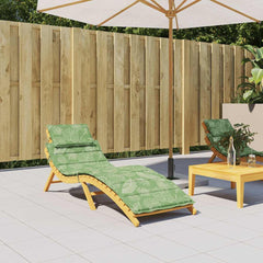 A green sun lounger cushion with a white leaf pattern on a wooden lounger.
