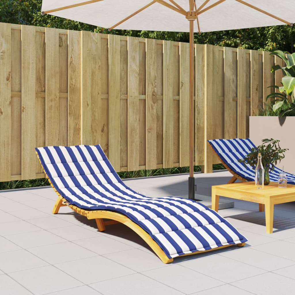 Blue and white striped Oxford fabric cushion on a wooden sun lounger in an outdoor patio setting.