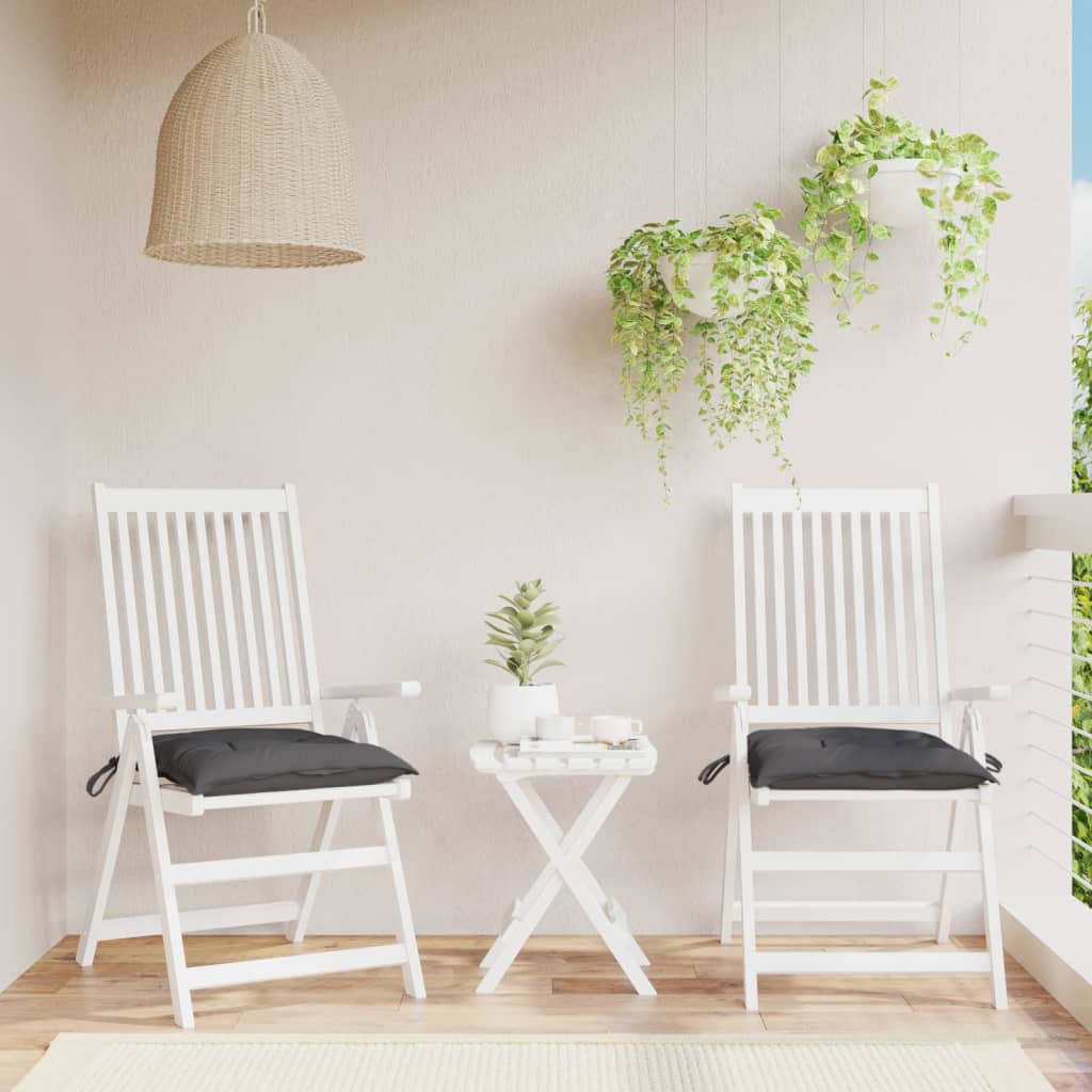 Two anthracite Oxford fabric chair cushions on white patio chairs with a small table.