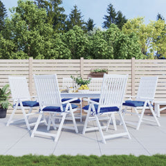 White outdoor dining table with six chairs, each with blue Oxford fabric cushions.