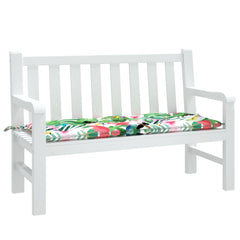 White garden bench with a multicolor fabric cushion featuring tropical leaf patterns.