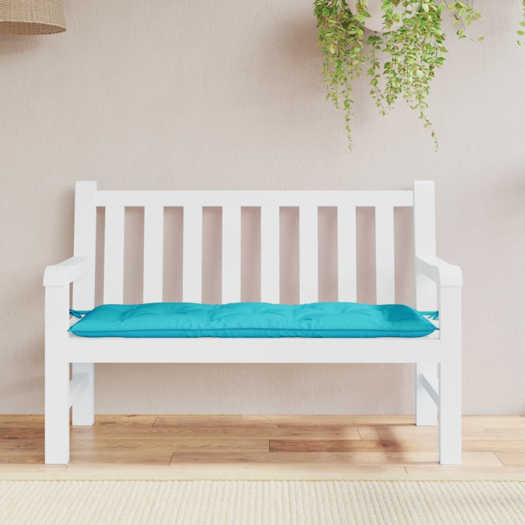 Turquoise polyester garden bench cushion, 47x20x3 inches, with tie-down straps.