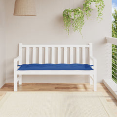 White wooden garden bench with royal blue Oxford fabric cushion on a balcony.