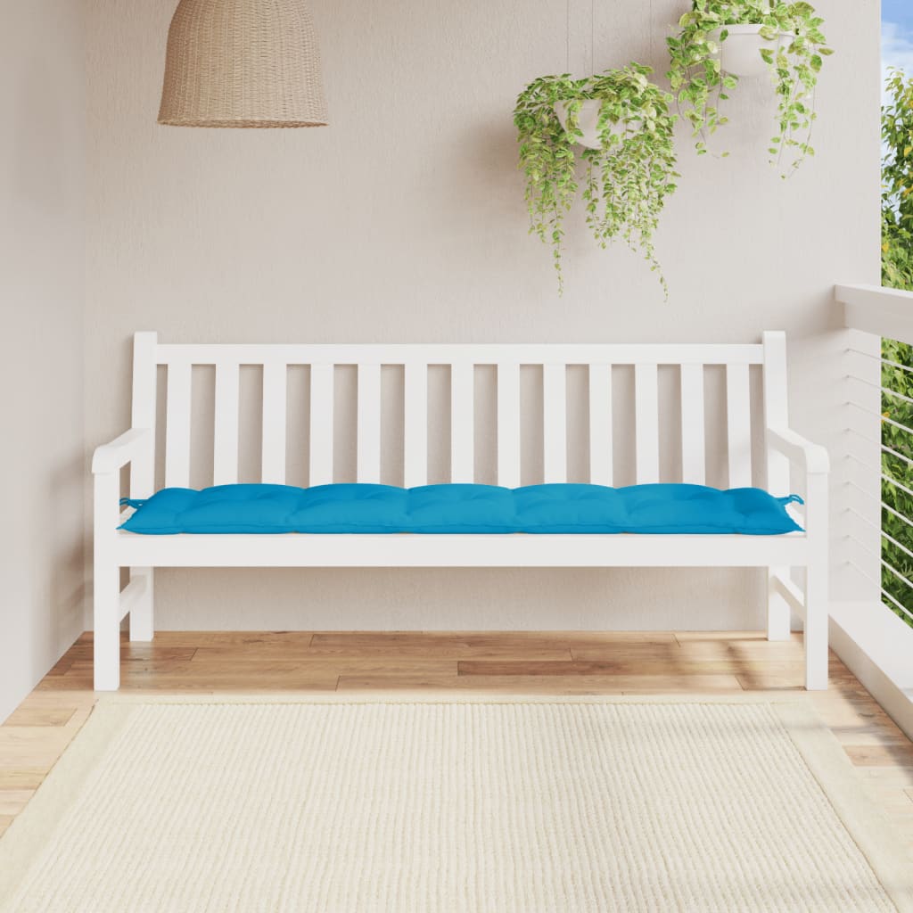 Light blue Oxford fabric garden bench cushion on white bench in sunny balcony setting.