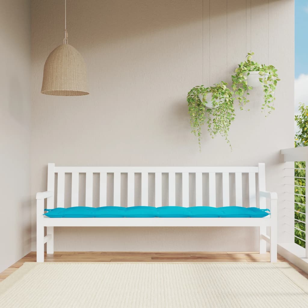 Turquoise polyester garden bench cushion with blue padding on white bench.