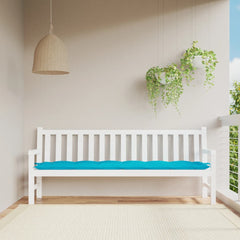 Turquoise polyester garden bench cushion with blue padding on white bench.