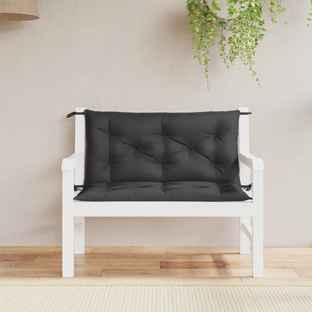 Two black Oxford fabric garden bench cushions with ties, sized 39.4x19.7x2.8 inches, on a white wooden bench.