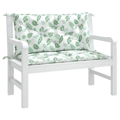 Two-piece leaf-pattern Oxford fabric cushions for a white garden bench, with seat and back pillows tied in place.