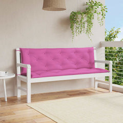 Two pink tufted fabric bench cushions with ties on a white garden bench.
