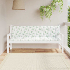 Two green leaf-patterned bench cushions on a white outdoor bench.