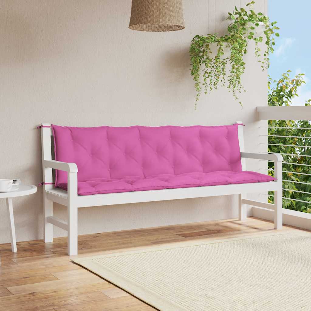 Two pink Oxford fabric cushions on a white garden bench in an outdoor setting.