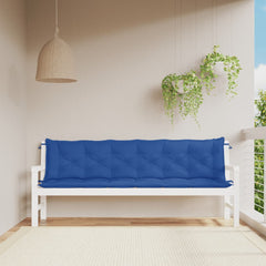 Two blue Oxford fabric bench cushions on a white garden bench in a sunny outdoor setting.